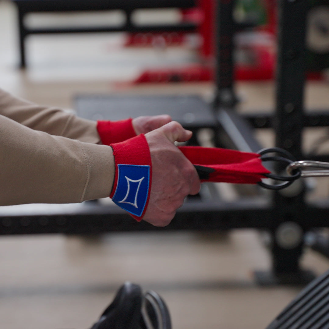 User demonstrating Grip-Less Straps in gym, focusing on pulling motion without grip strain.