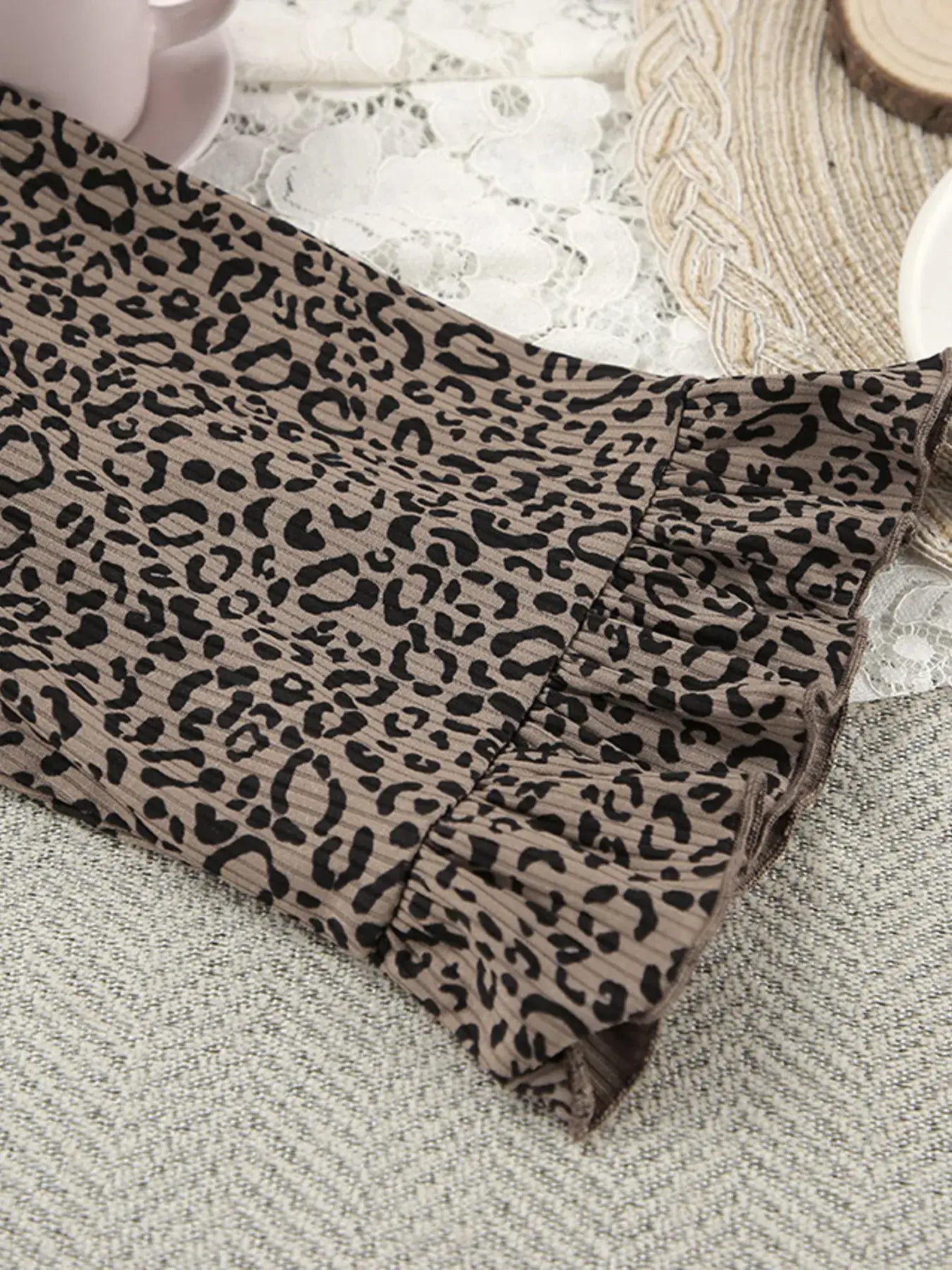Leopard Cami Cardigan and Shorts 3-Piece Set fabric close-up featuring a stylish leopard print with slight ruffles.