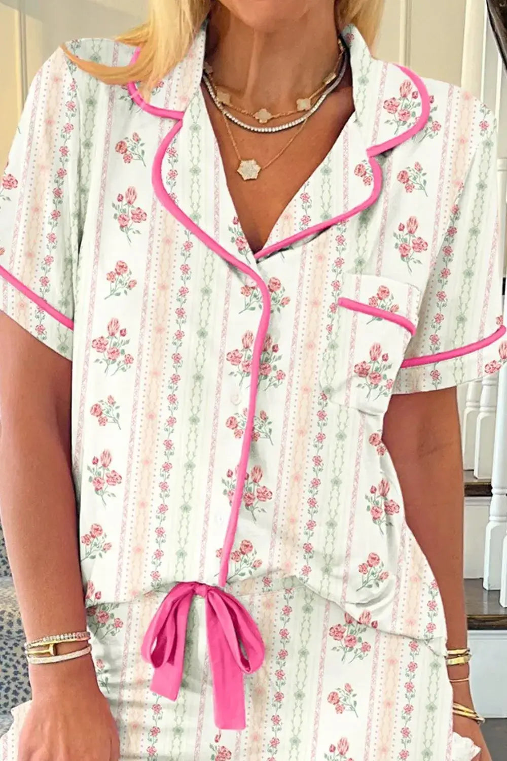 Floral Printed Button Up Short Sleeve Top and Shorts Lounge Set featuring pink trim, floral pattern, and drawstring bow detail.