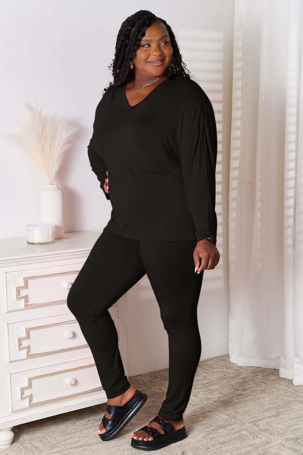 Basic Bae Full Size V-Neck Soft Rayon Long Sleeve Top and Pants Lounge Set in black on model, showcasing comfort and style.