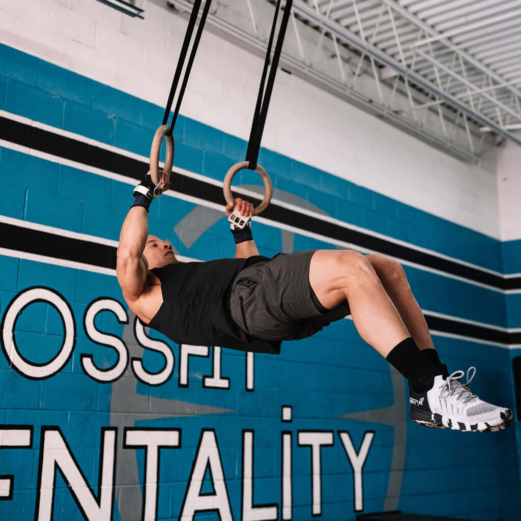 Athlete using Element 26 Vise Grips during a workout on gym rings to prevent hand tears and maximize performance.