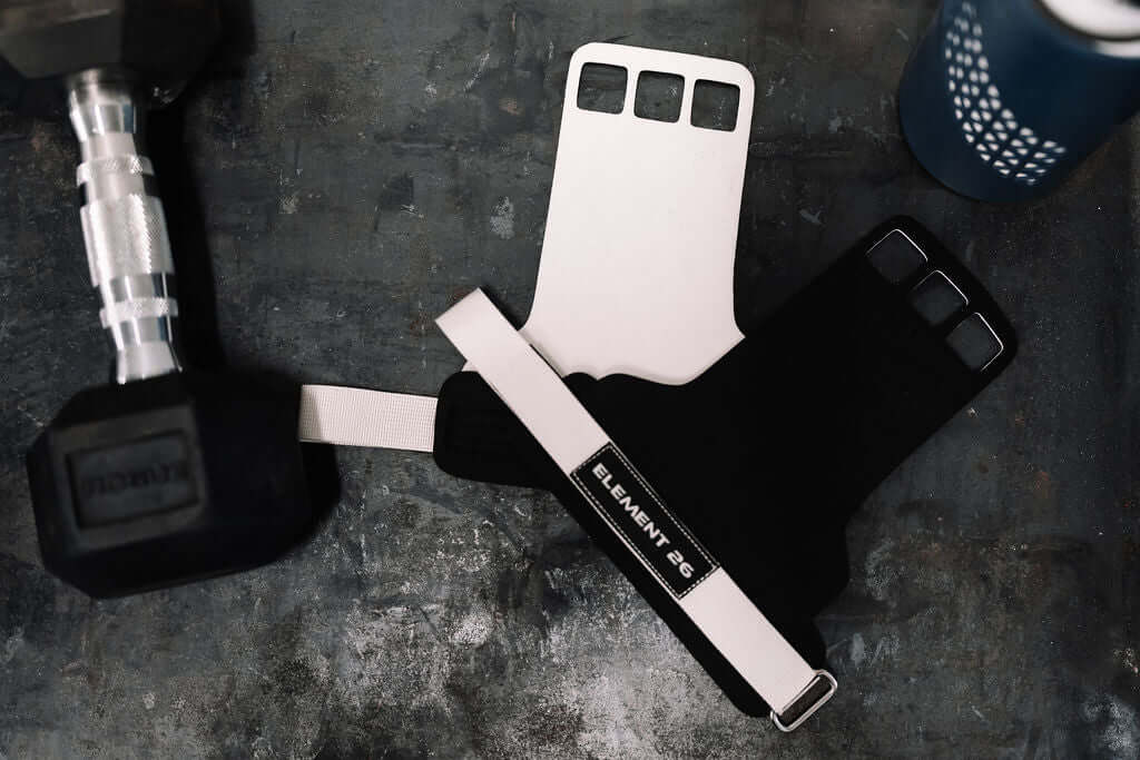Element 26 Vise Grips beside a dumbbell, designed to prevent hand tears during workouts.