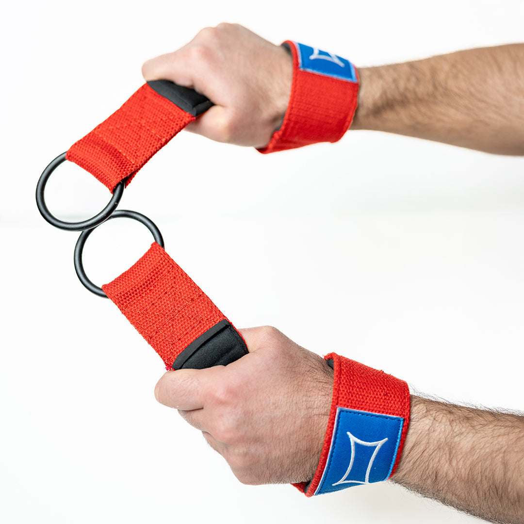 Close-up of hands using Grip-Less Straps with rings for strength training and back exercises.