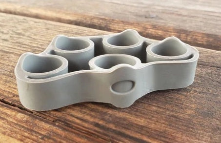 Silicone Finger Trainer Hand Gripper Resistance Bands Fitness in gray color on wooden surface.