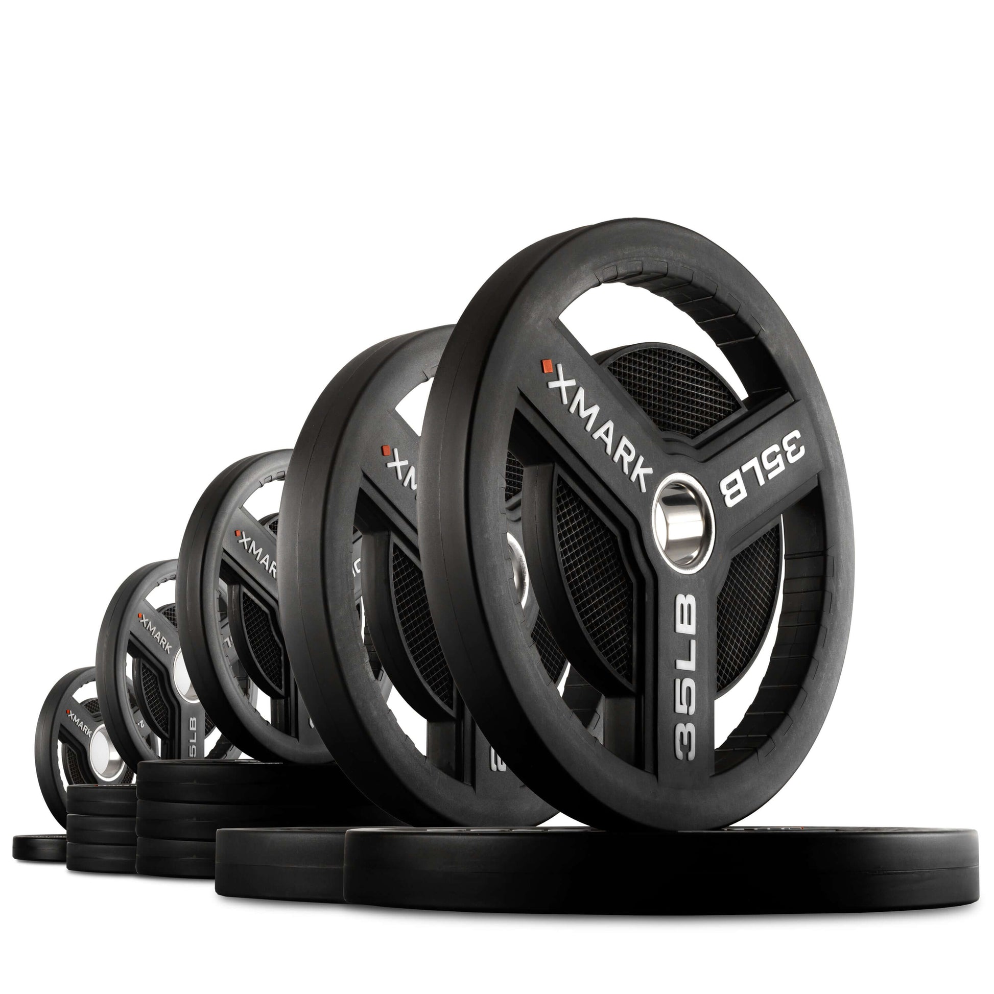 Commercial Urethane Olympic Weight Plates displayed in a row showcasing their durable design and tri-grip handles.