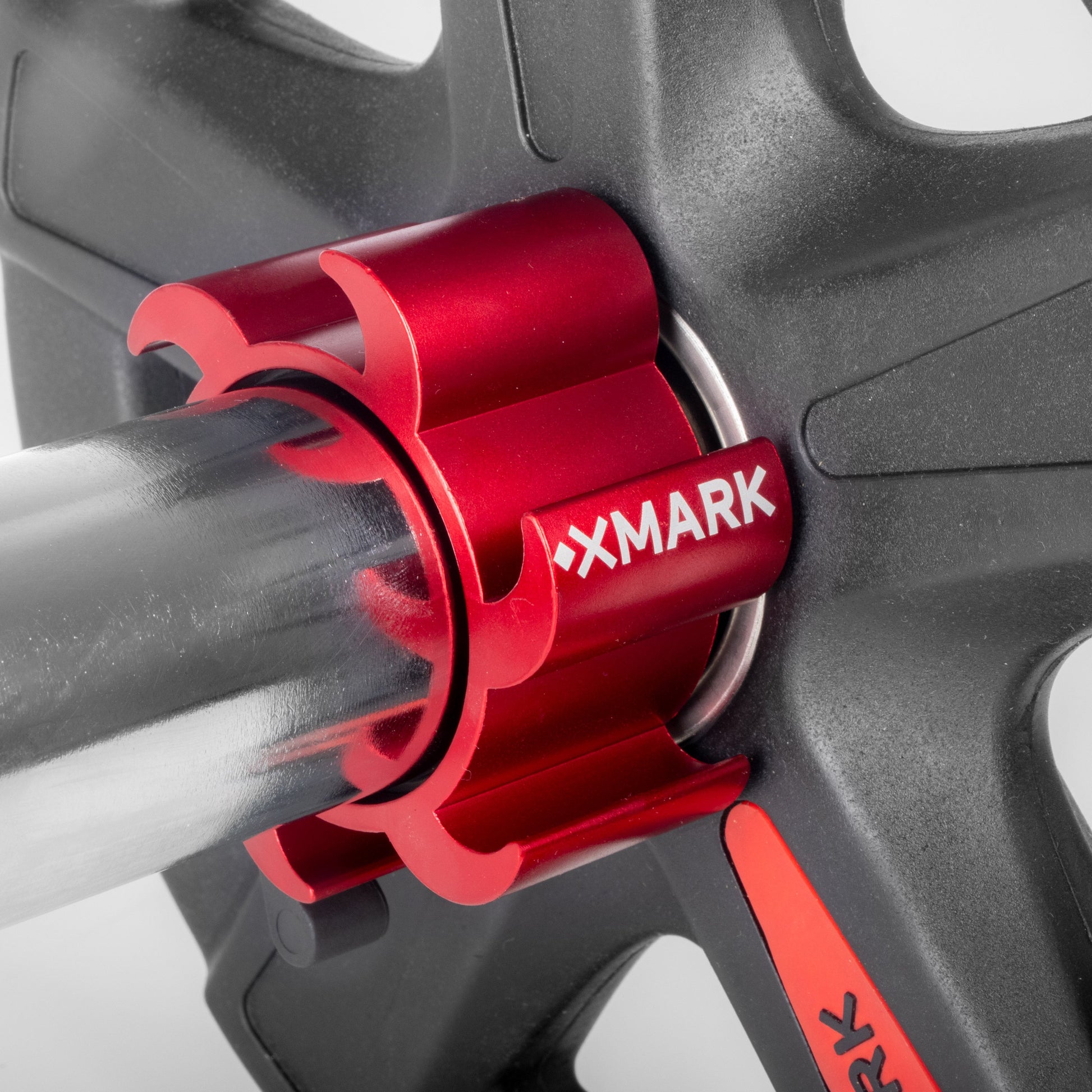 Aluminum Olympic Barbell Quick Release Collars securely fastening a weight plate on an Olympic barbell.