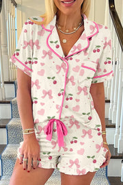 Floral Printed Button Up Short Sleeve Top and Shorts Lounge Set, featuring pink bows and hearts, perfect for lounging.