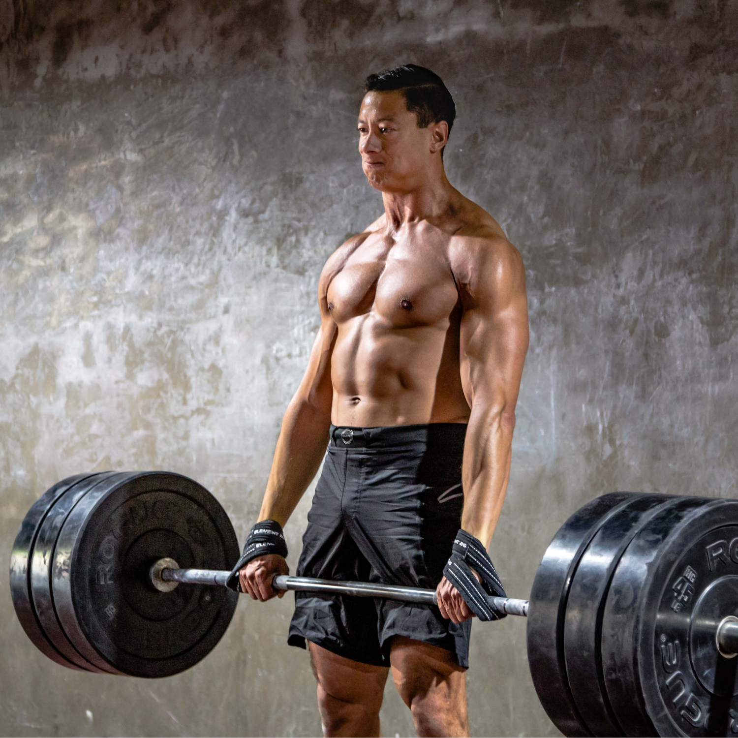 Man lifting a heavy barbell with Padded Figure 8 Weightlifting Straps for effective grip and support.