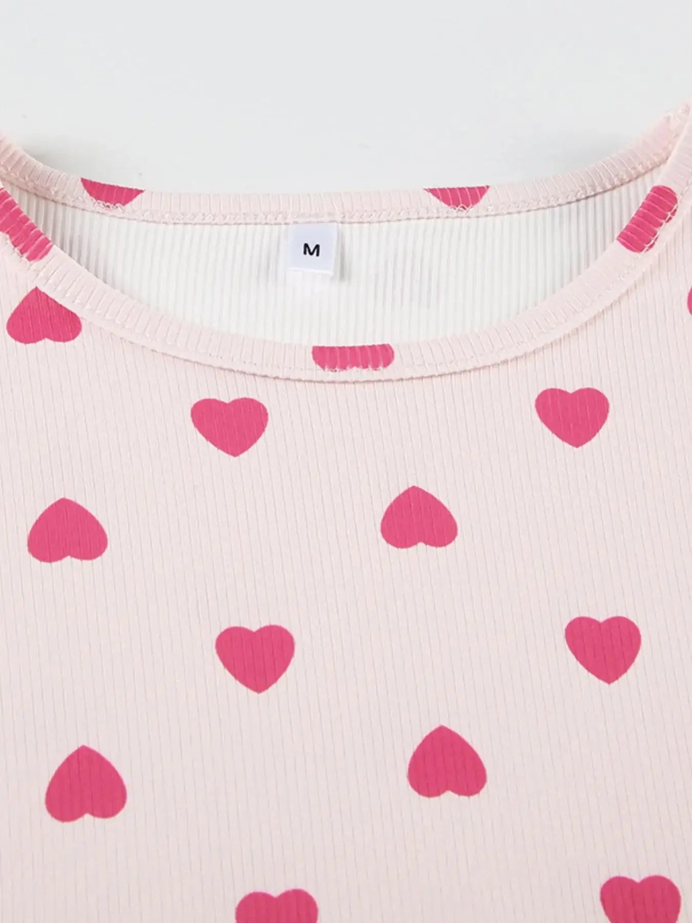 Heart Print Top and Shorts Loungewear Set featuring pink heart patterns on a light fabric with a 'M' size label.