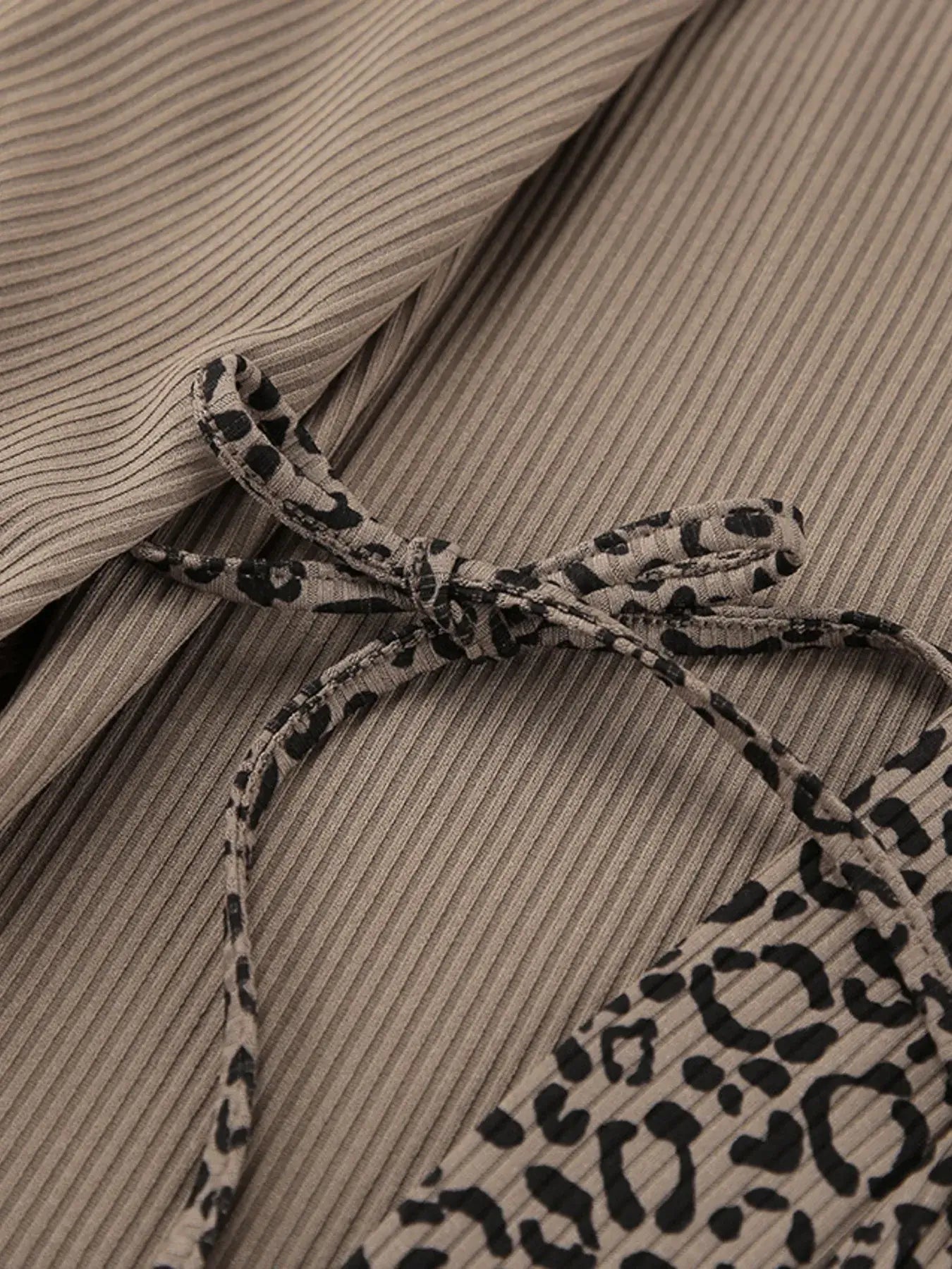 Close-up of the Leopard Cami Cardigan and Shorts 3-Piece Set showing the tied detail and fabric texture.