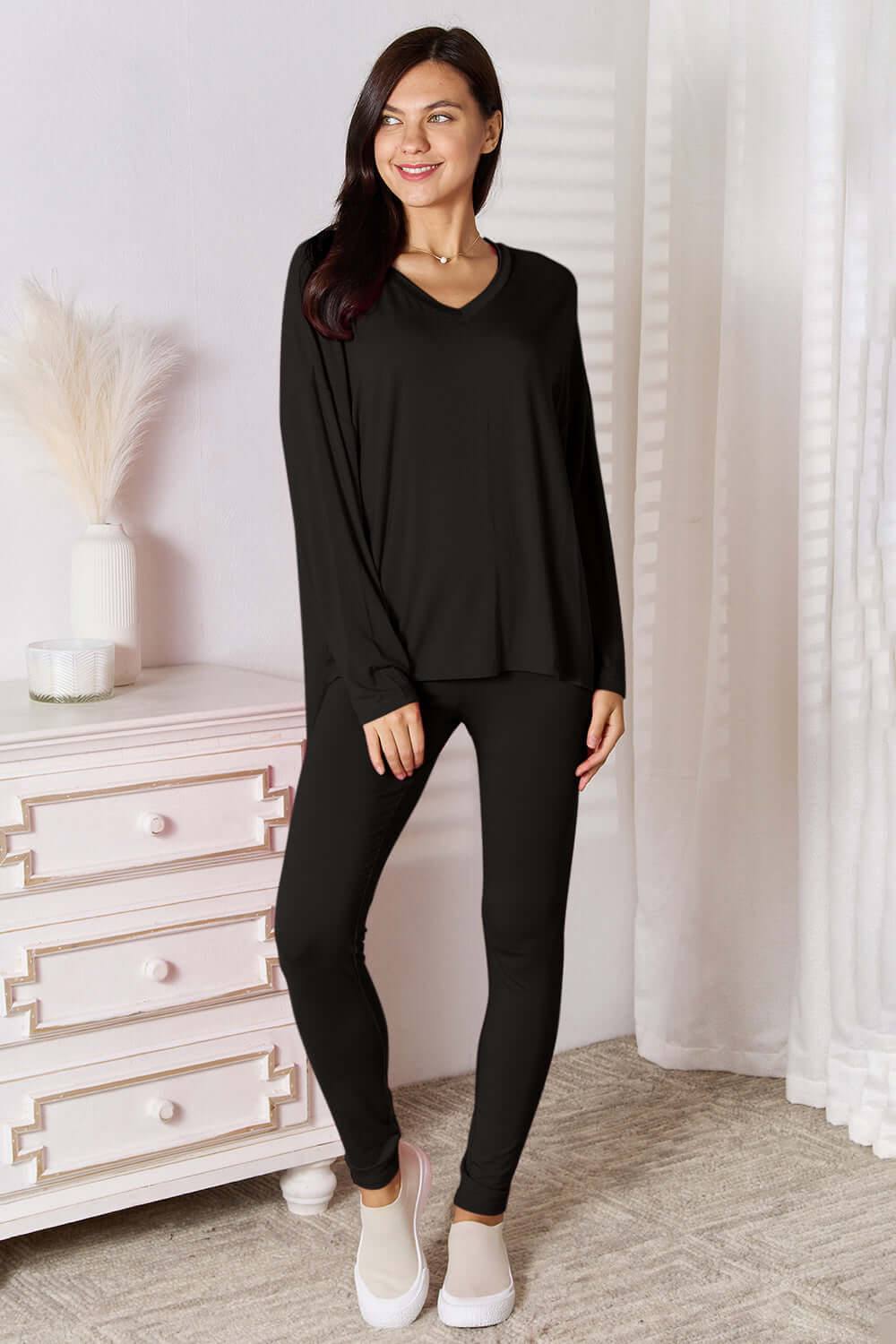 Basic Bae Full Size V-Neck Soft Rayon Long Sleeve Top and Pants Lounge Set in black worn by a model.