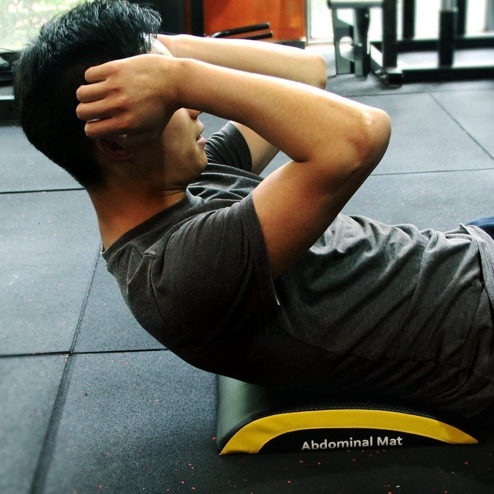 Person using Portable Sit-up Training Mat Fitness Equipment during abdominal workout in gym.