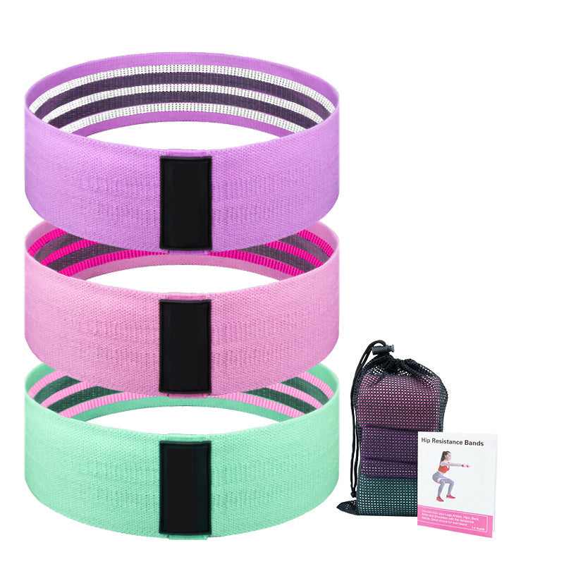 Fabric Resistance Bands by Vellmara in lake blue, pink, and purple with black clips and a net bag.