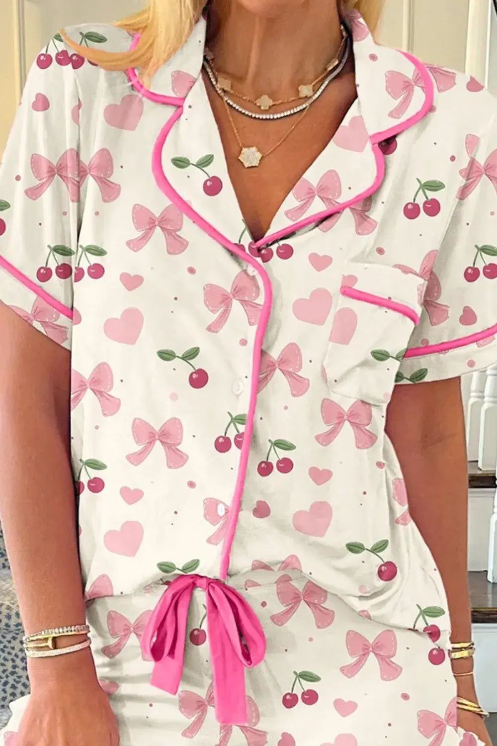 Floral Printed Button Up Short Sleeve Top and Shorts Lounge Set with pink bows and cherries on a white background.