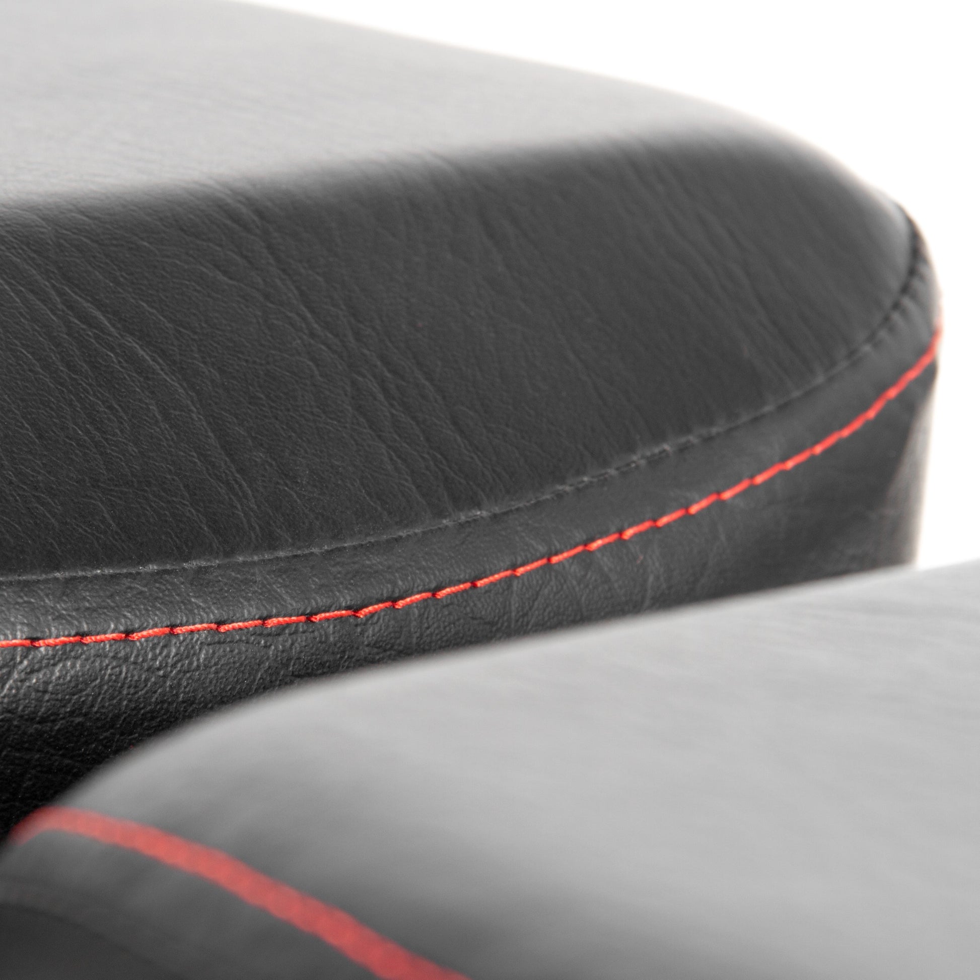 Close-up view of the cushioned surface of the Power Series Adjustable Dumbbell Weight Bench with red stitching.