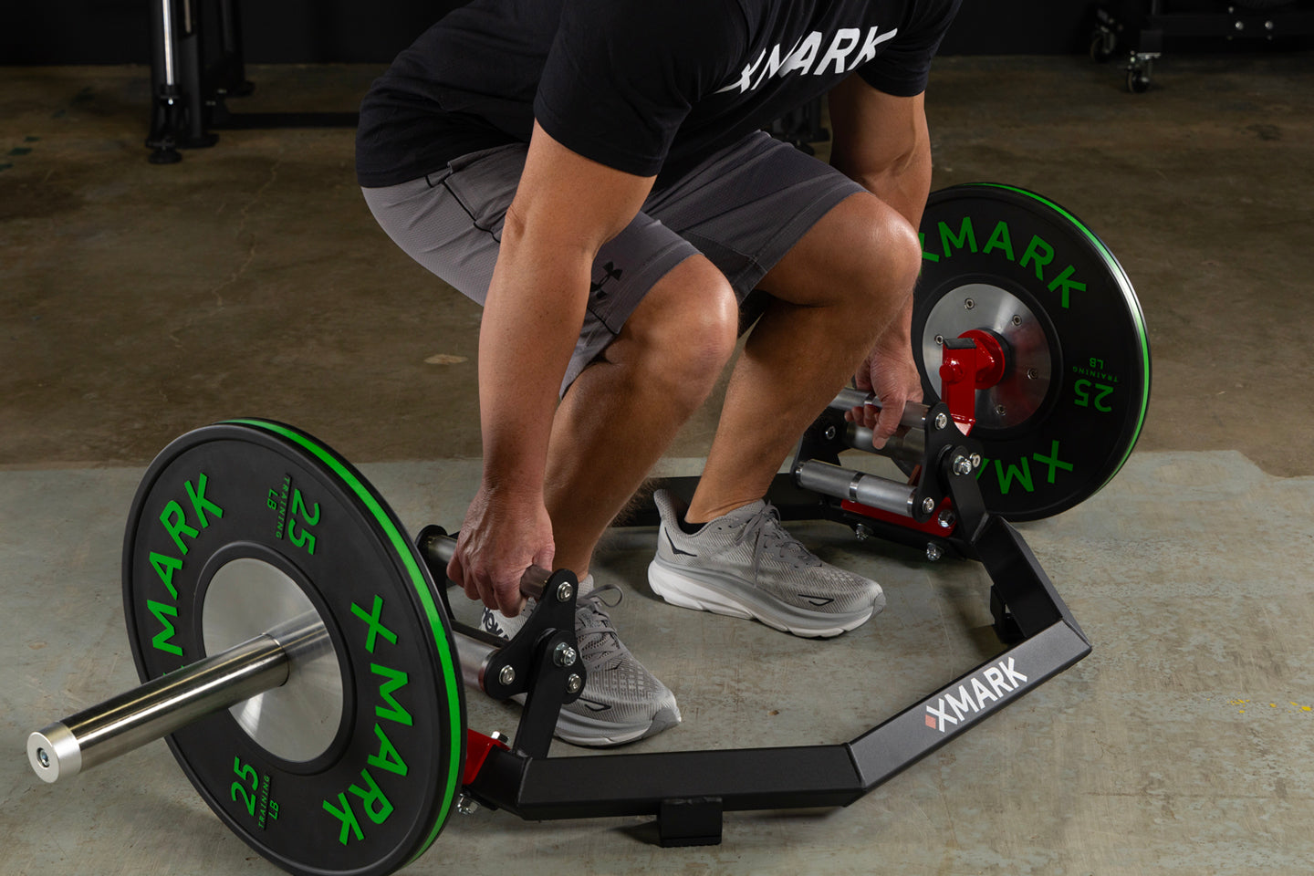 Person using Olympic Hex Trap Shrug Barbell with knurled grips and elevated sleeves for weightlifting exercises.