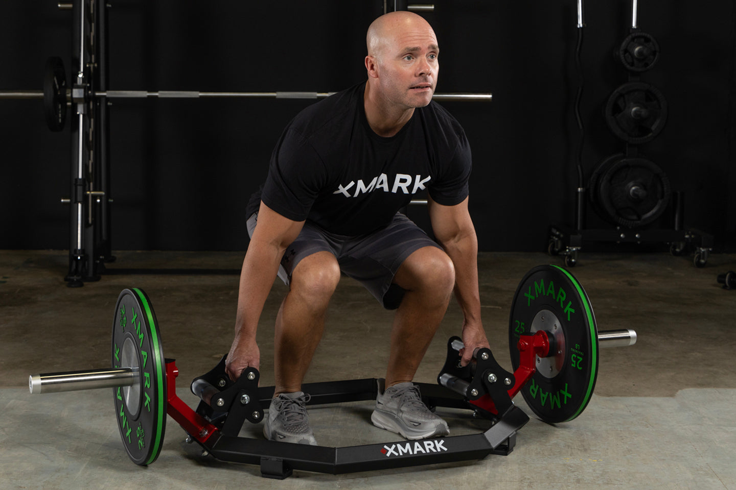 Man using Olympic Hex Trap Shrug Barbell with revolving tri-grip handles for weightlifting exercises.
