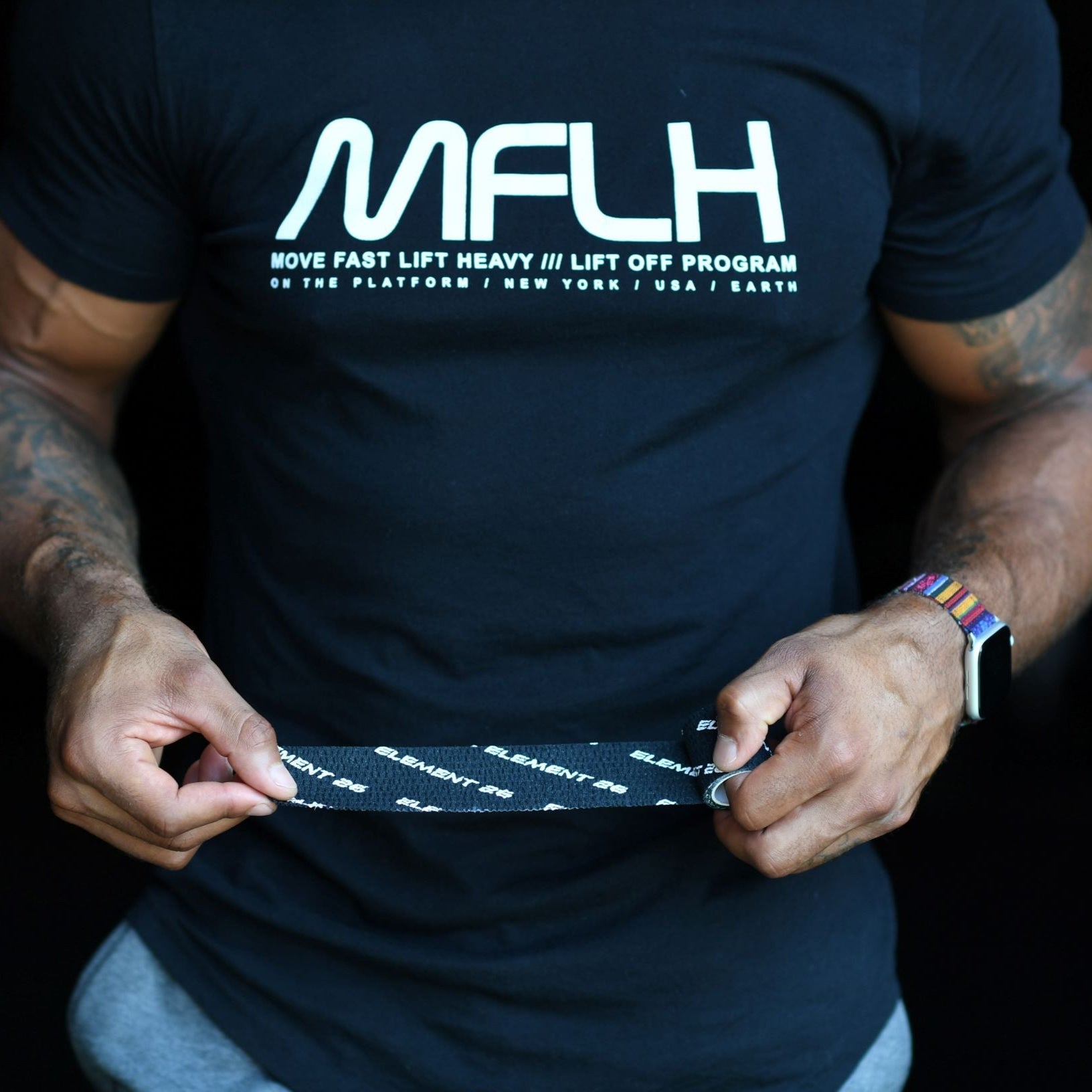 Weightlifting Tape displayed by a person wearing an athletic shirt, demonstrating grip and control during lifting.