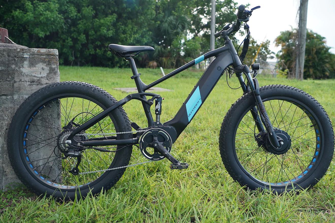 DEFENDER-S Performance Ebike featured in a grassy outdoor setting showcasing its robust design and fat tires.