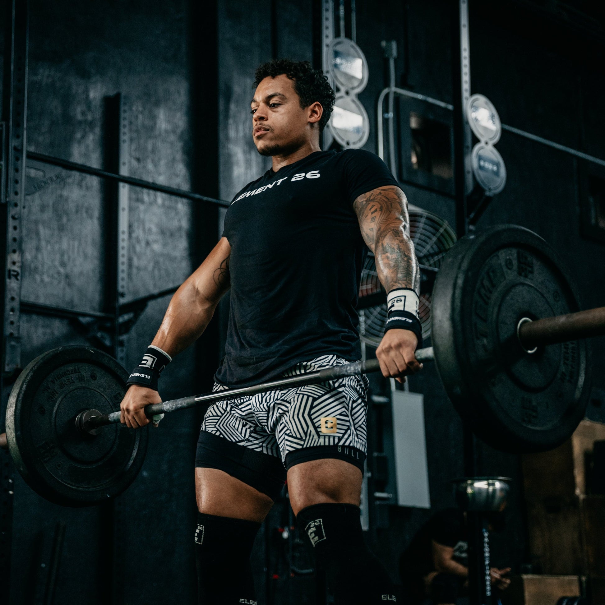 Weight Lifting Straps in use by a muscular athlete performing heavy deadlifts in a gym setting.