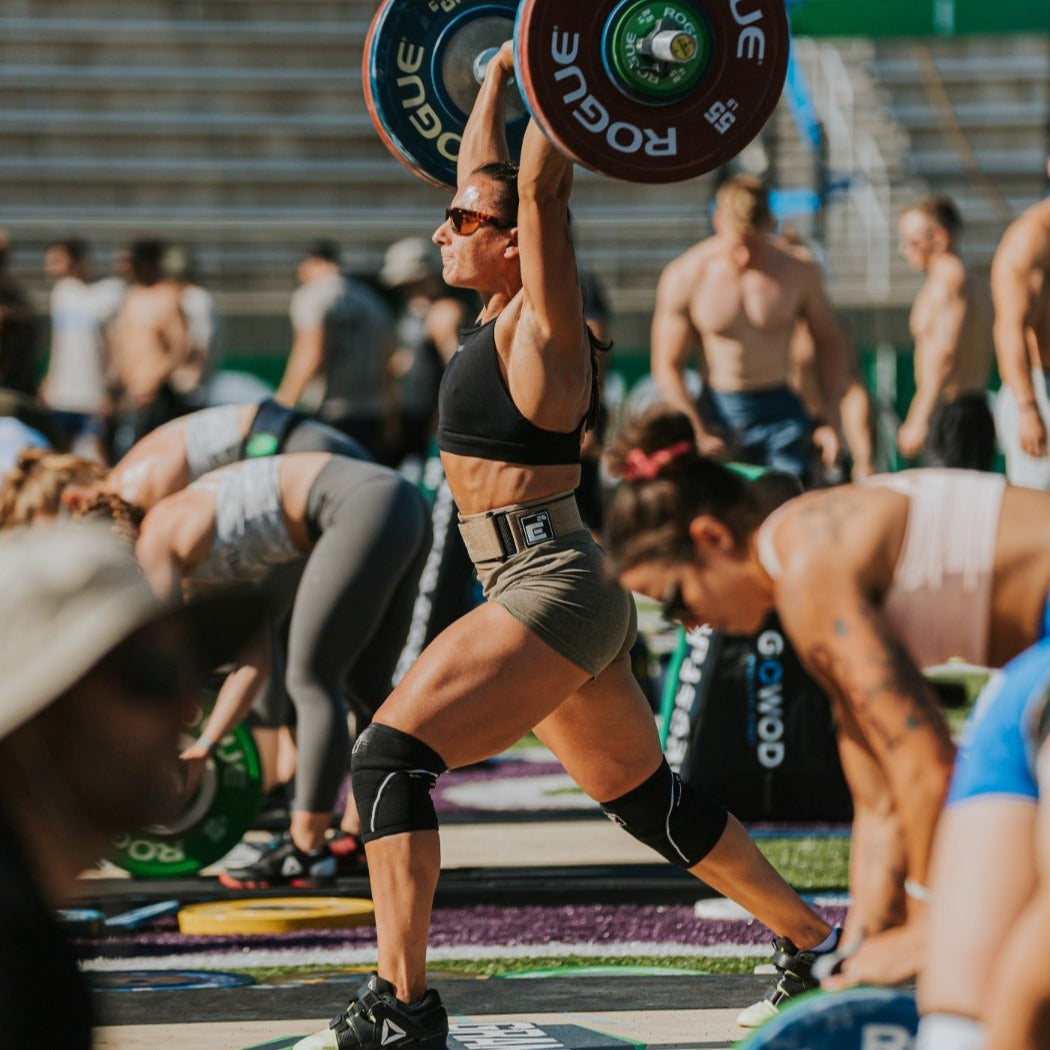 Athlete lifting weights with 6mm Knee Sleeves during a fitness competition.