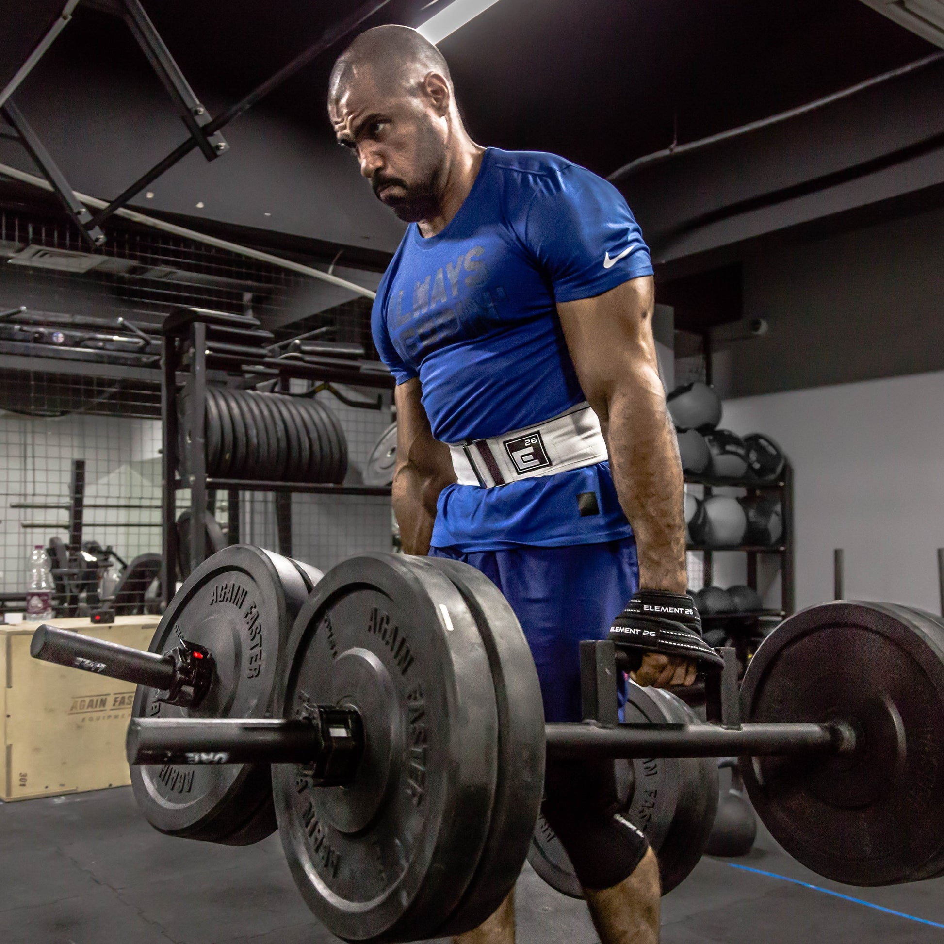 Man lifting heavy weights using Padded Figure 8 Weightlifting Straps for deadlifts and strength training.