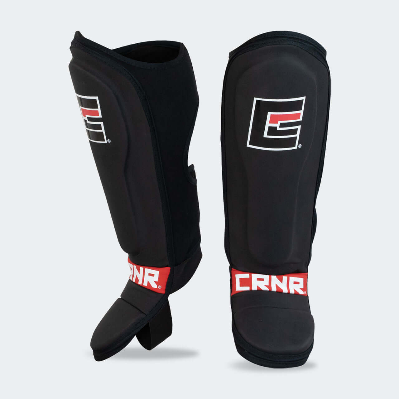 Kids MMA Spar Shin Guards by COMBAT CORNER in black with red accents, designed for youth martial artists.