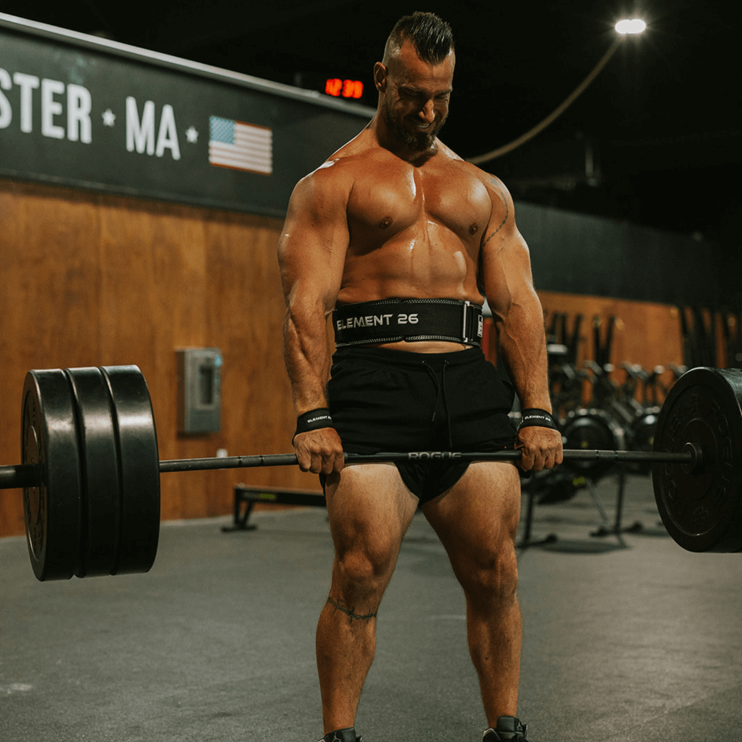 Strong individual lifting weights with a Hybrid Leather Weightlifting Belt for optimal support and performance.