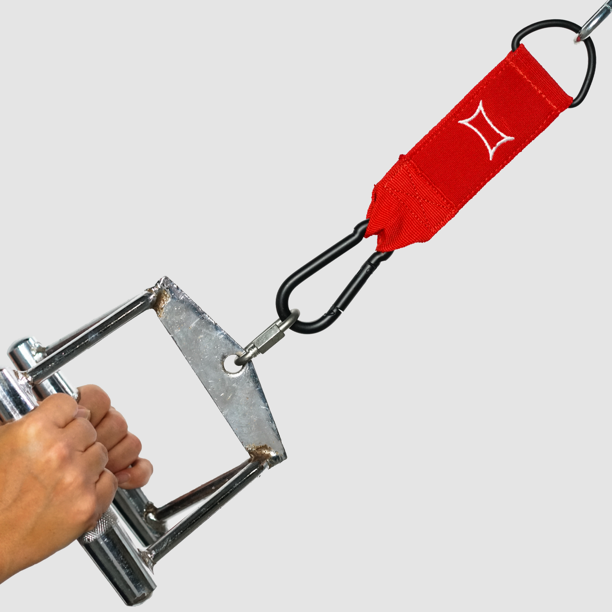 Close-up of a hand holding the Nylon Shake Strap Adapter attached to a cable machine with a carabiner.