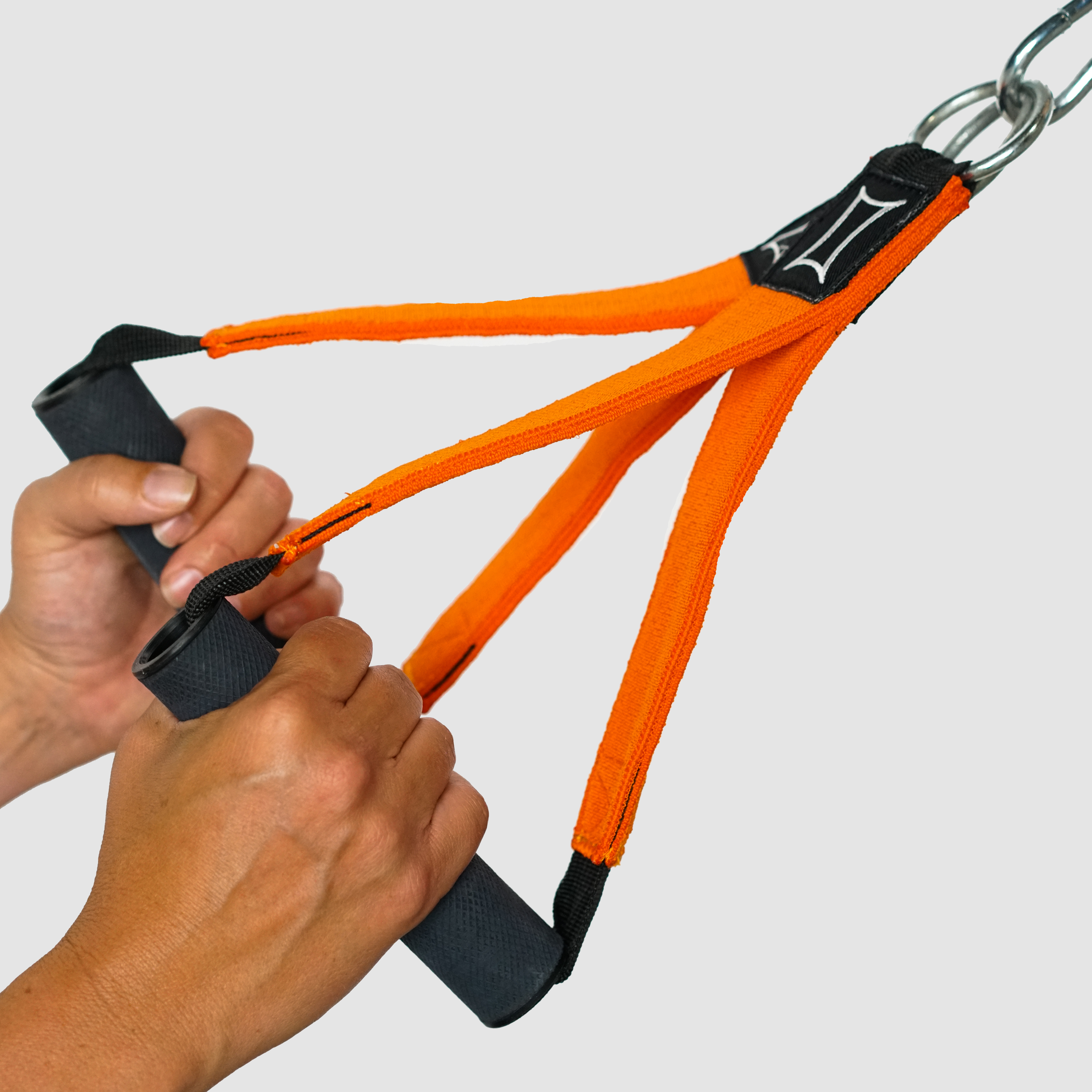 Hands holding a Shake Handle Attachment with orange slingshot material for cable machines.