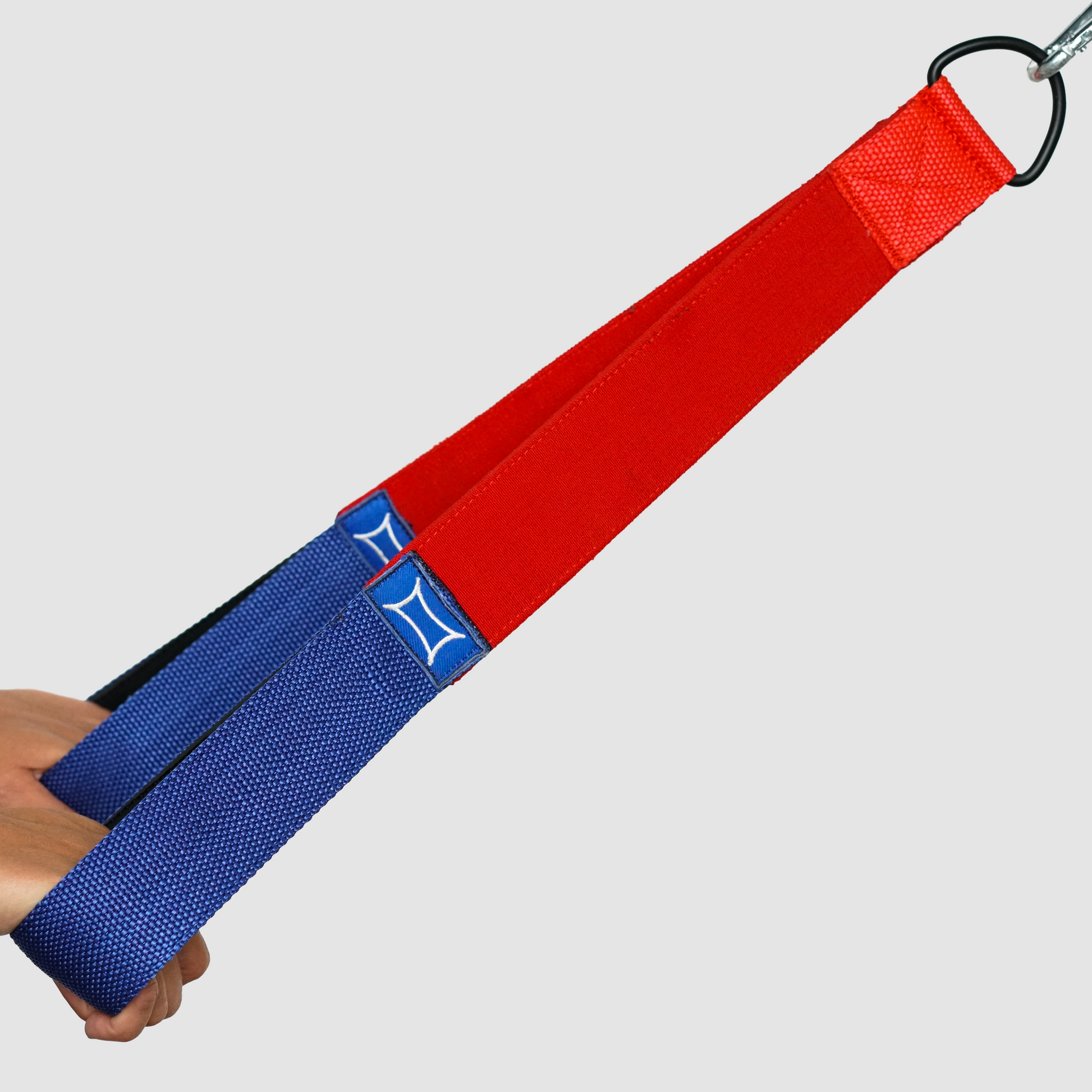 Nylon Tricep Shake Strap attached to cable machine with two handles for to enhance tricep workouts.