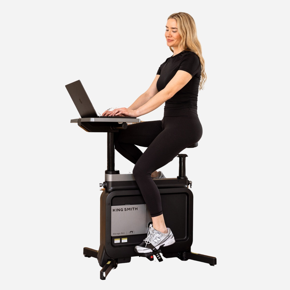 Woman using W1B 3 IN 1 Foldable Exercise Under Desk Bike while working on a laptop.