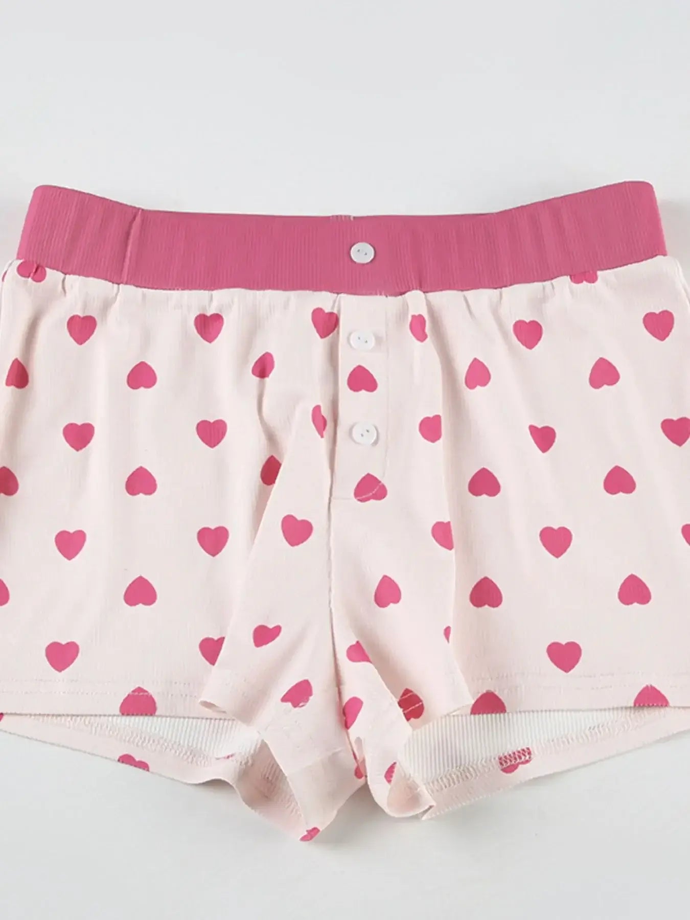 Heart Print Top and Shorts Loungewear Set featuring pink heart pattern shorts with button details and elastic waistband.