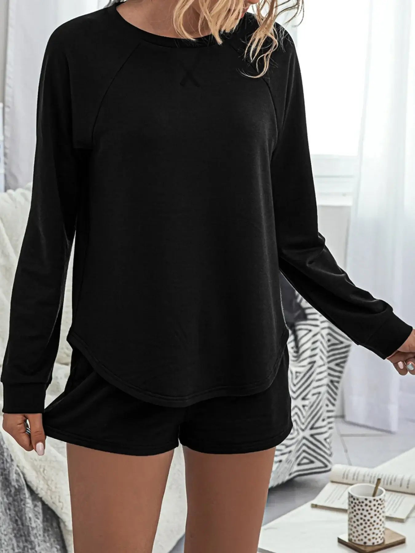 Round Neck Raglan Sleeve Top and Shorts Lounge Set in black worn by a model, showcasing cozy lounge style.