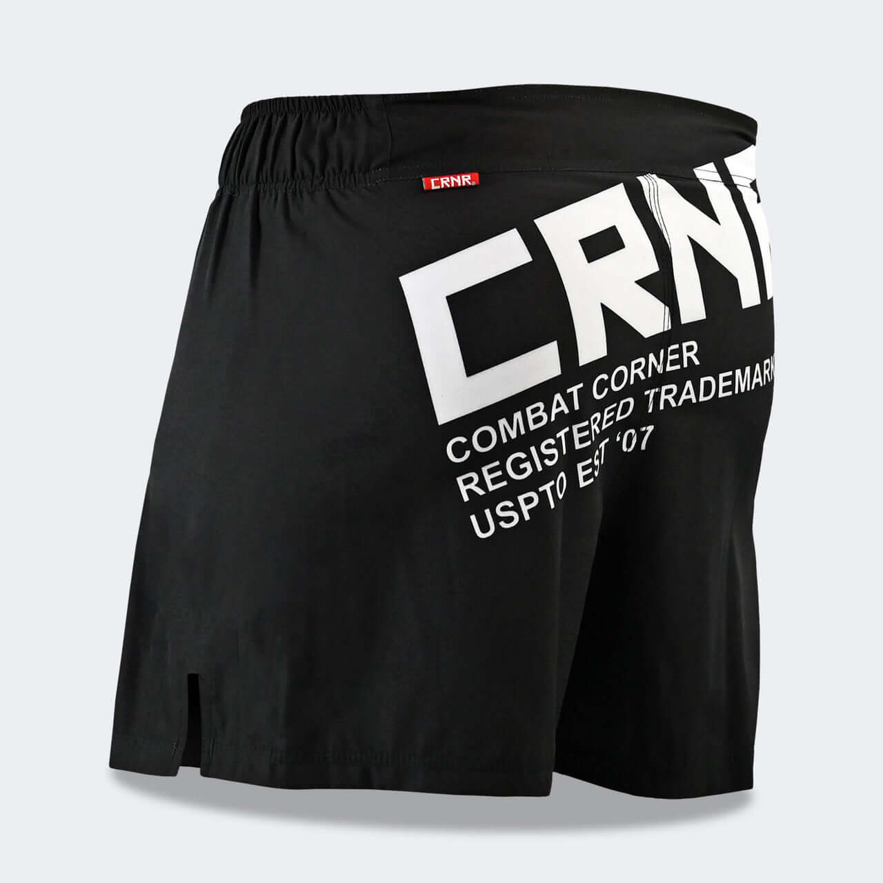 CROSS TRAINER SHORTS by Combat Corner in black featuring CRNR logo and lightweight design for martial arts training.