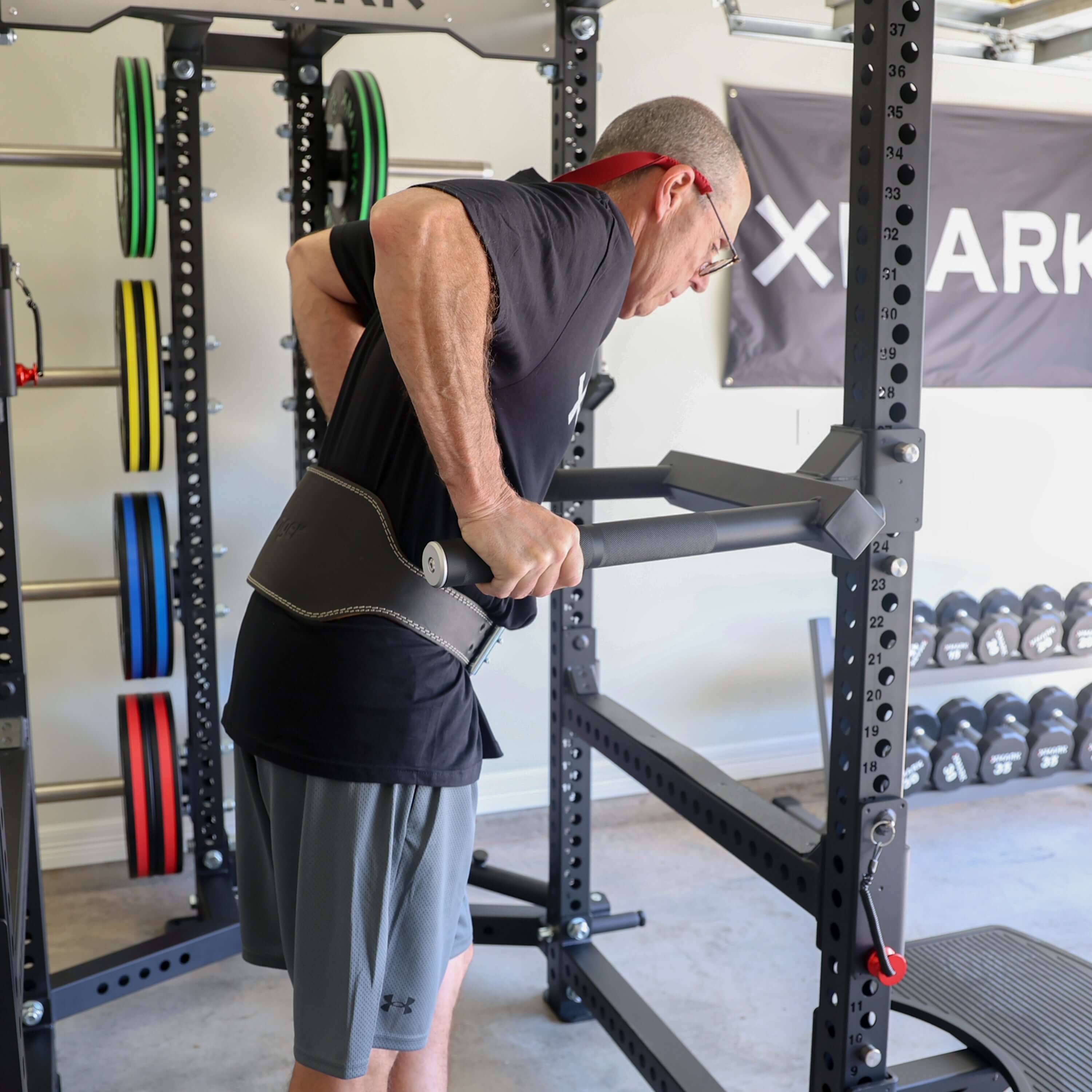 User performing triceps dips using the Viper Dip Handle Attachment on a power rack.