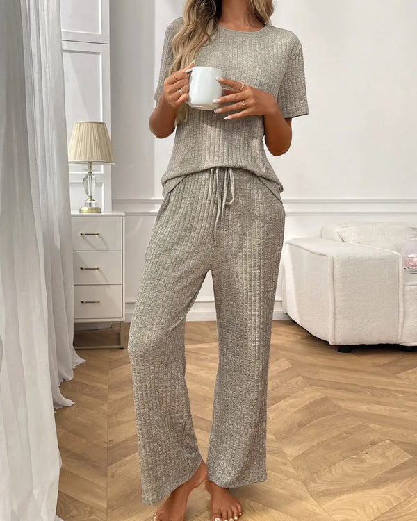 Ribbed Knit Short Sleeve Top and Pants Lounge Set worn by a woman holding a mug in a stylish modern interior.