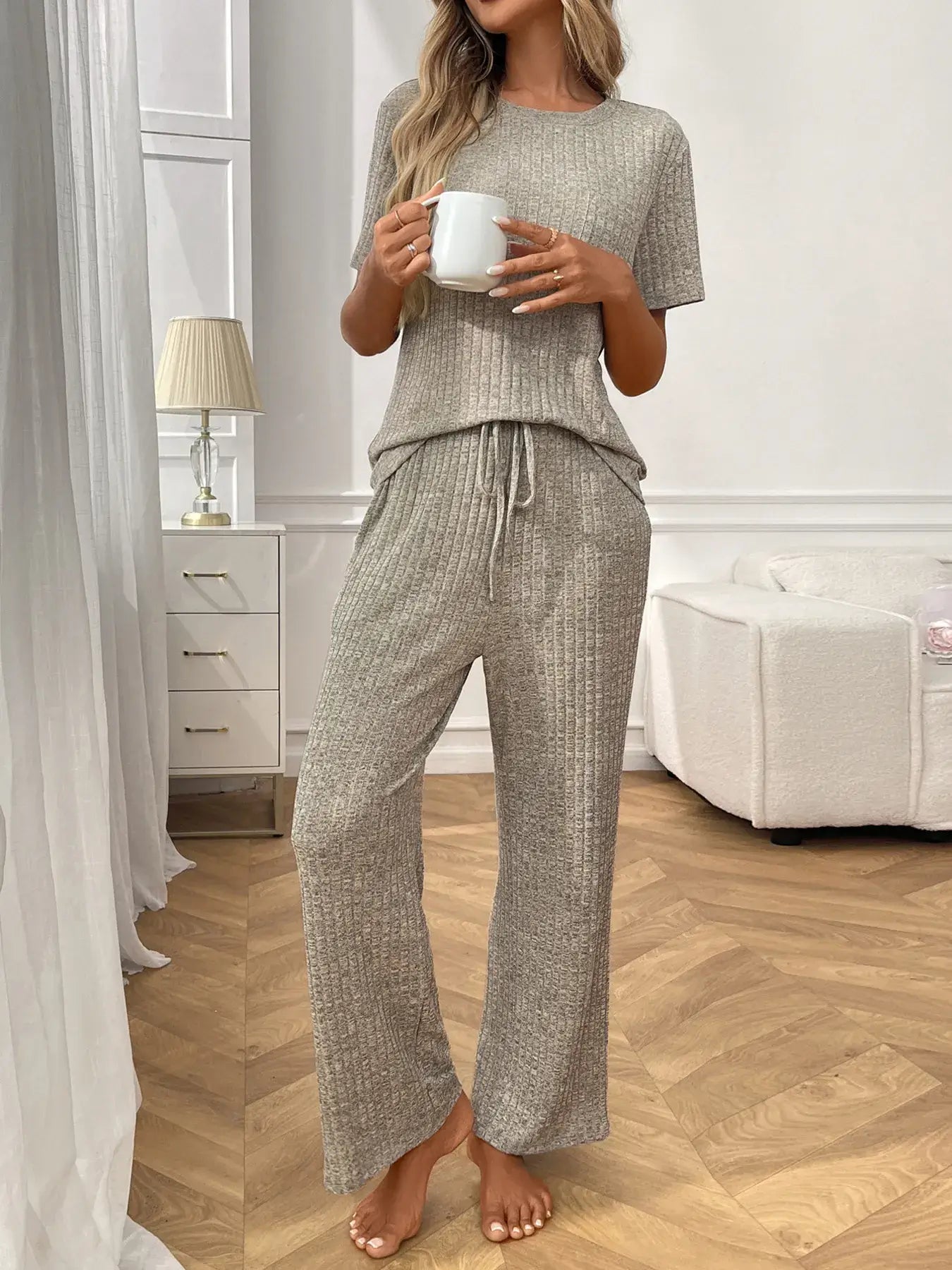 Ribbed Knit Short Sleeve Top and Pants Lounge Set worn by a woman holding a mug in a stylish modern interior.