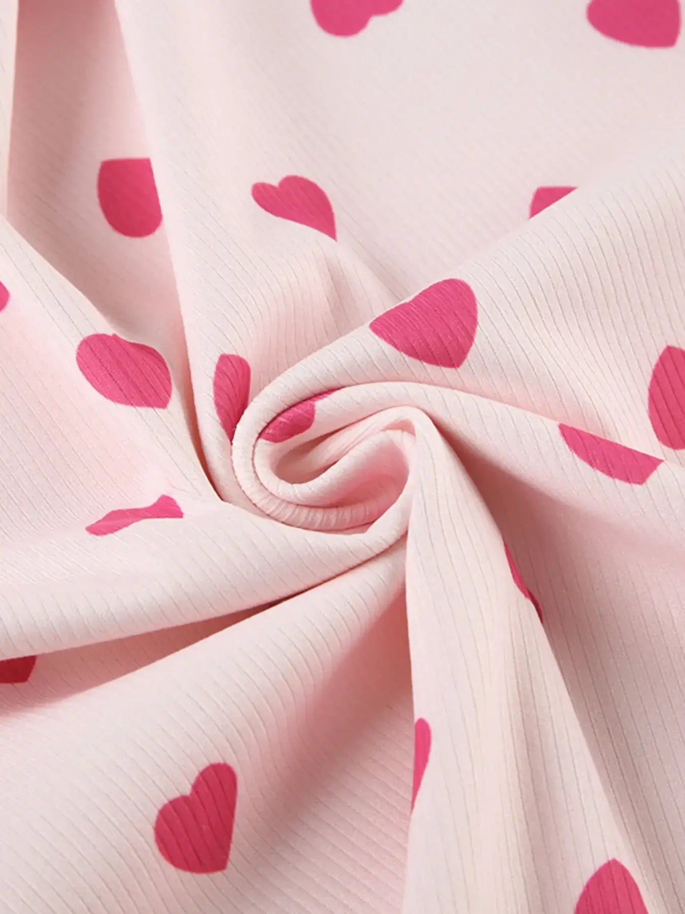 Heart Print Top and Shorts Loungewear Set soft fabric close-up featuring pink heart prints on a light background.