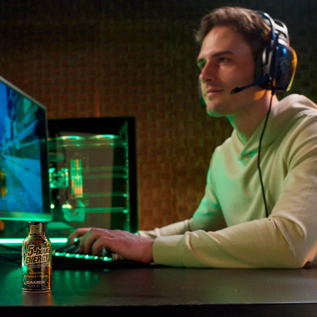 Gamer enjoying Pineapple Charge Extra Strength 5-hour ENERGY Shots while playing video games.