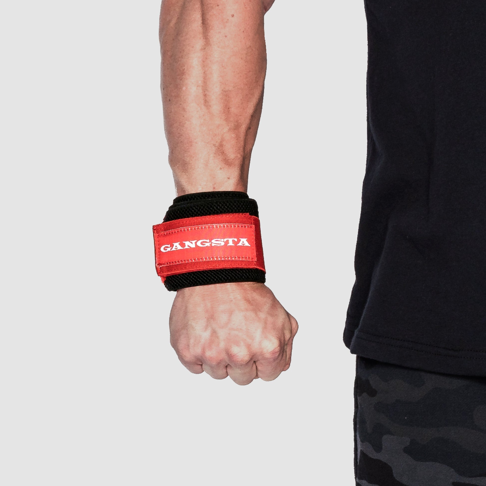 Gangsta Flex Wrist Wraps providing support and stability on a wrist during strength training.