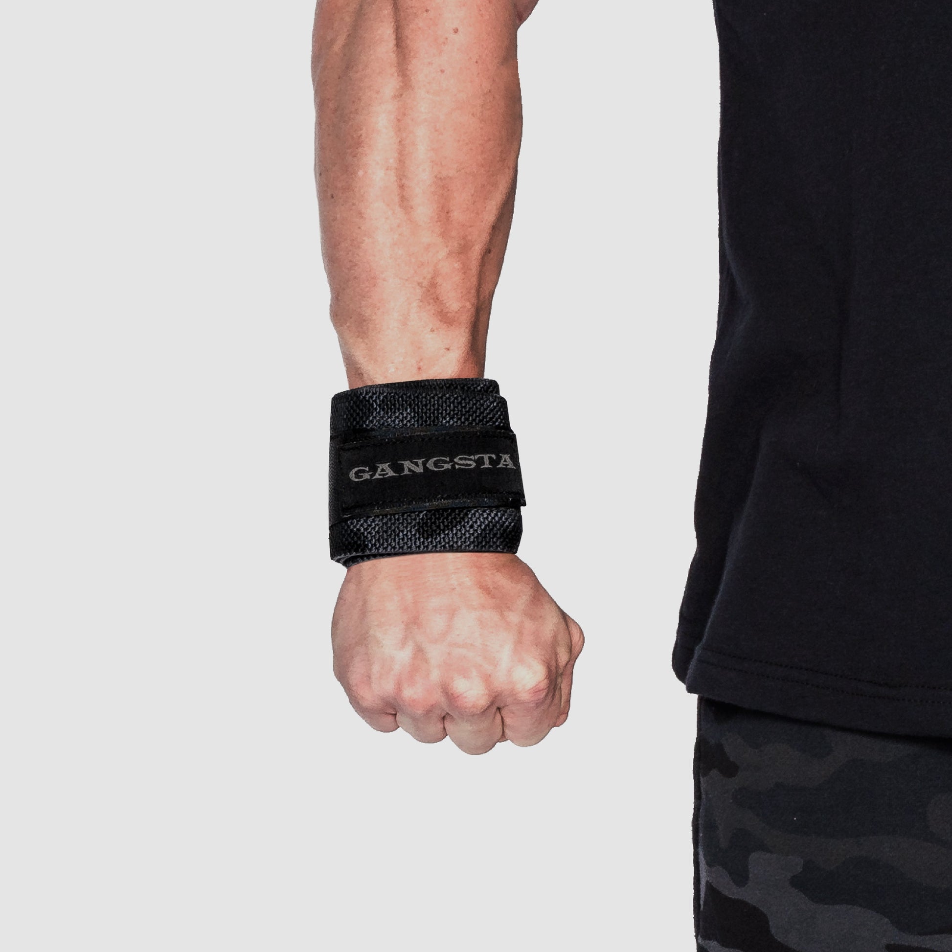 Gangsta Wraps Wrist Wraps worn on a wrist for support during weightlifting and strength training.