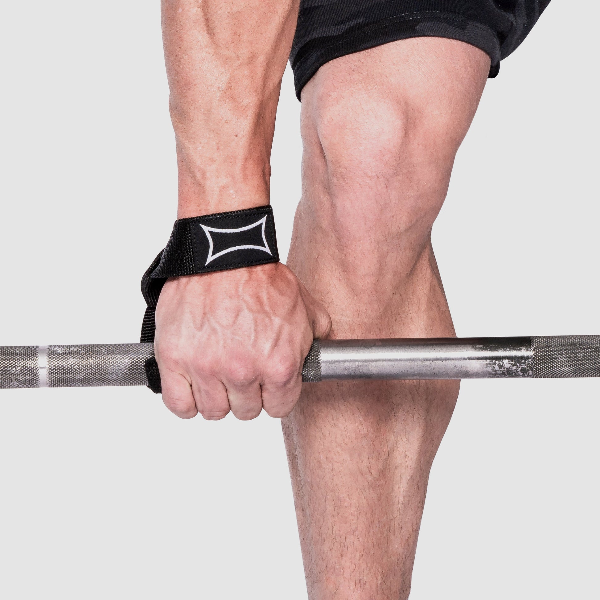 Close-up of a hand gripping a barbell using Nylon Lifting Straps for better grip during training.