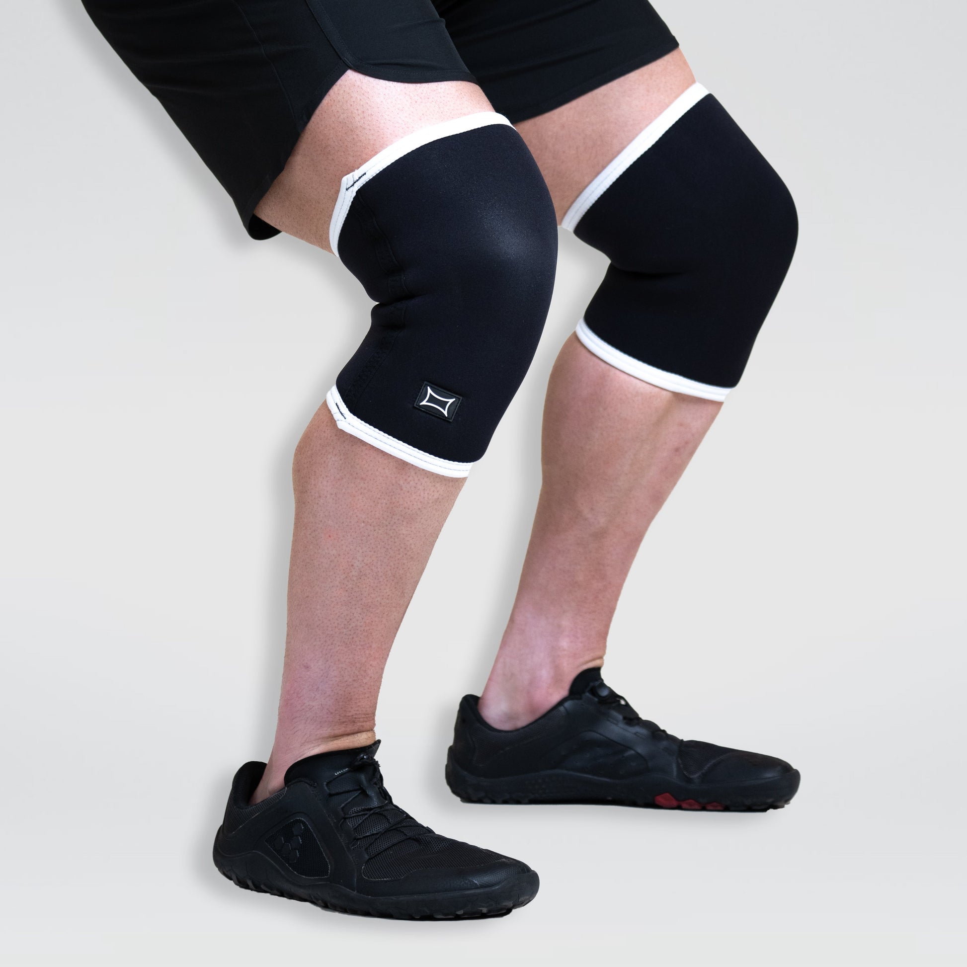 Athlete wearing Sling Shot Knee Sleeves for support and stability during training.