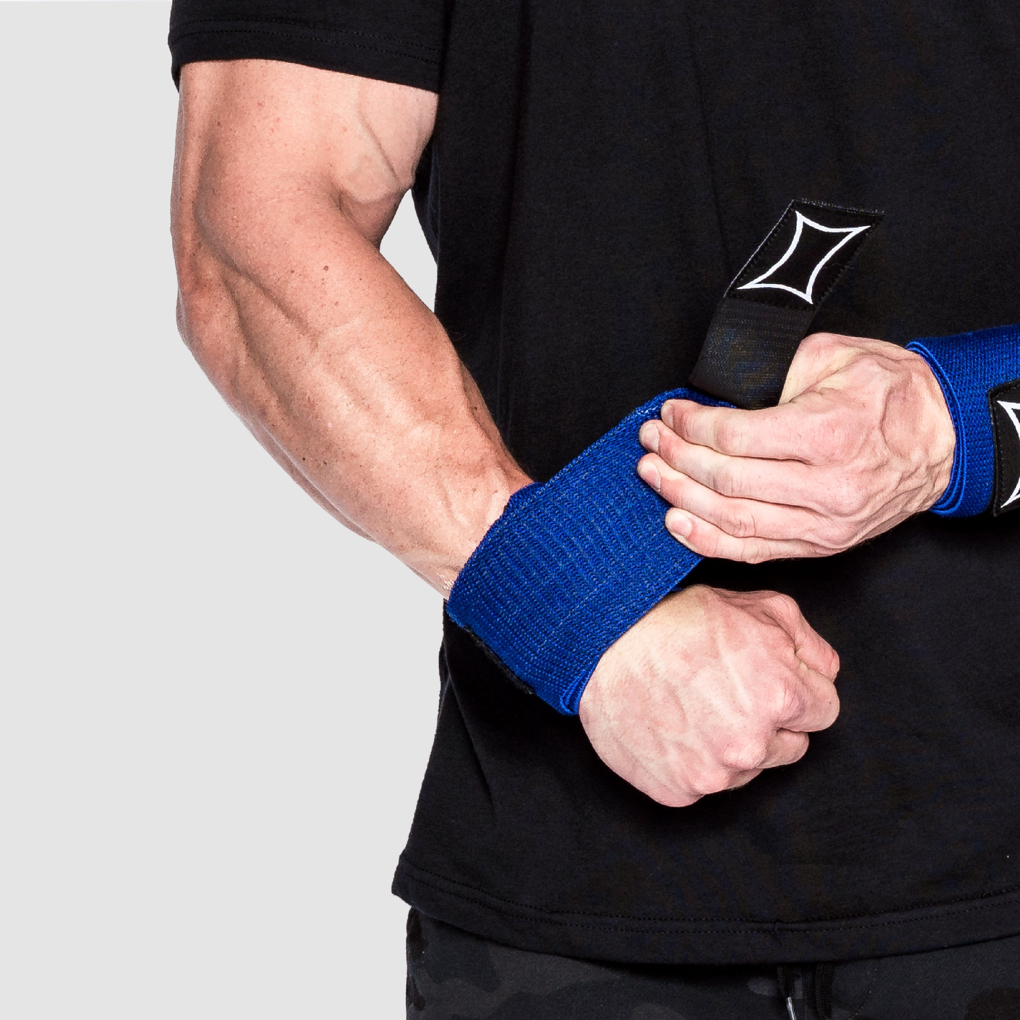 Sling Shot Wrist Wraps providing support during weightlifting for wrist and forearm stability.