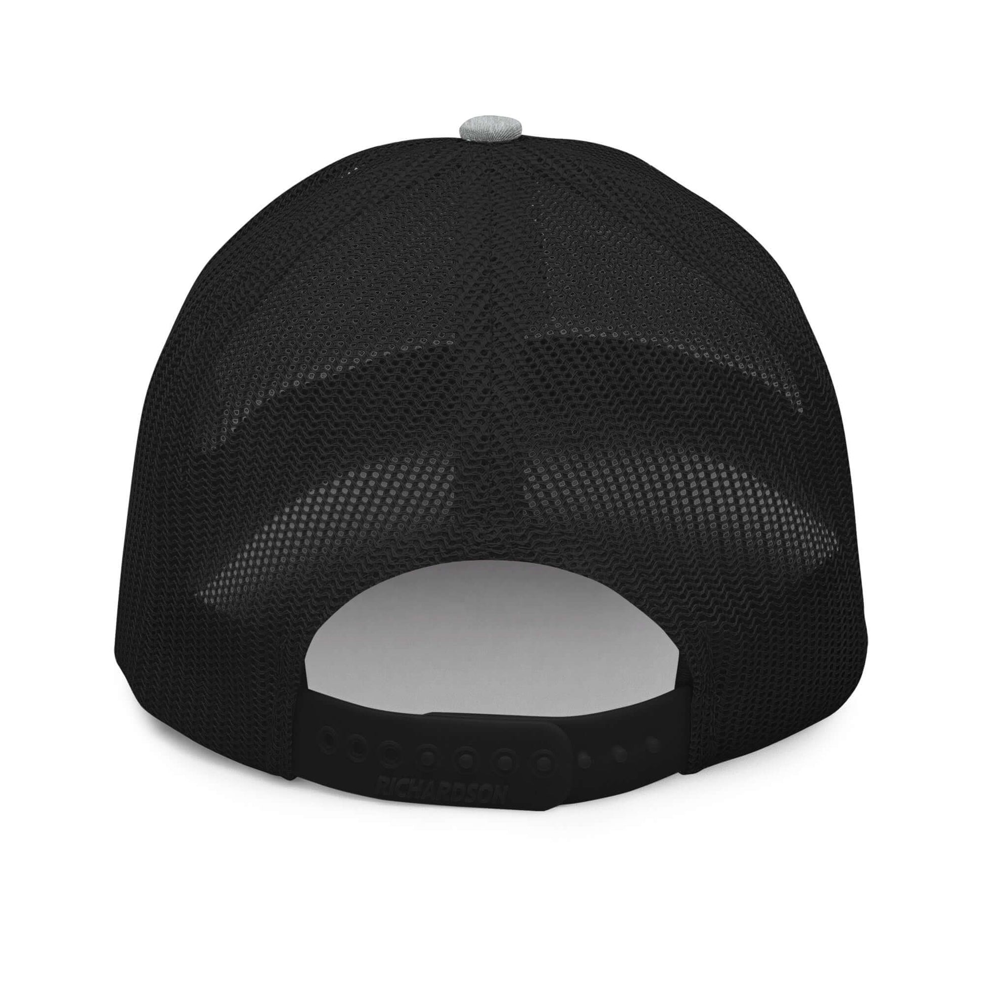 Back view of a black Trucker Hat By Vellmara with mesh panel and adjustable snapback closure.