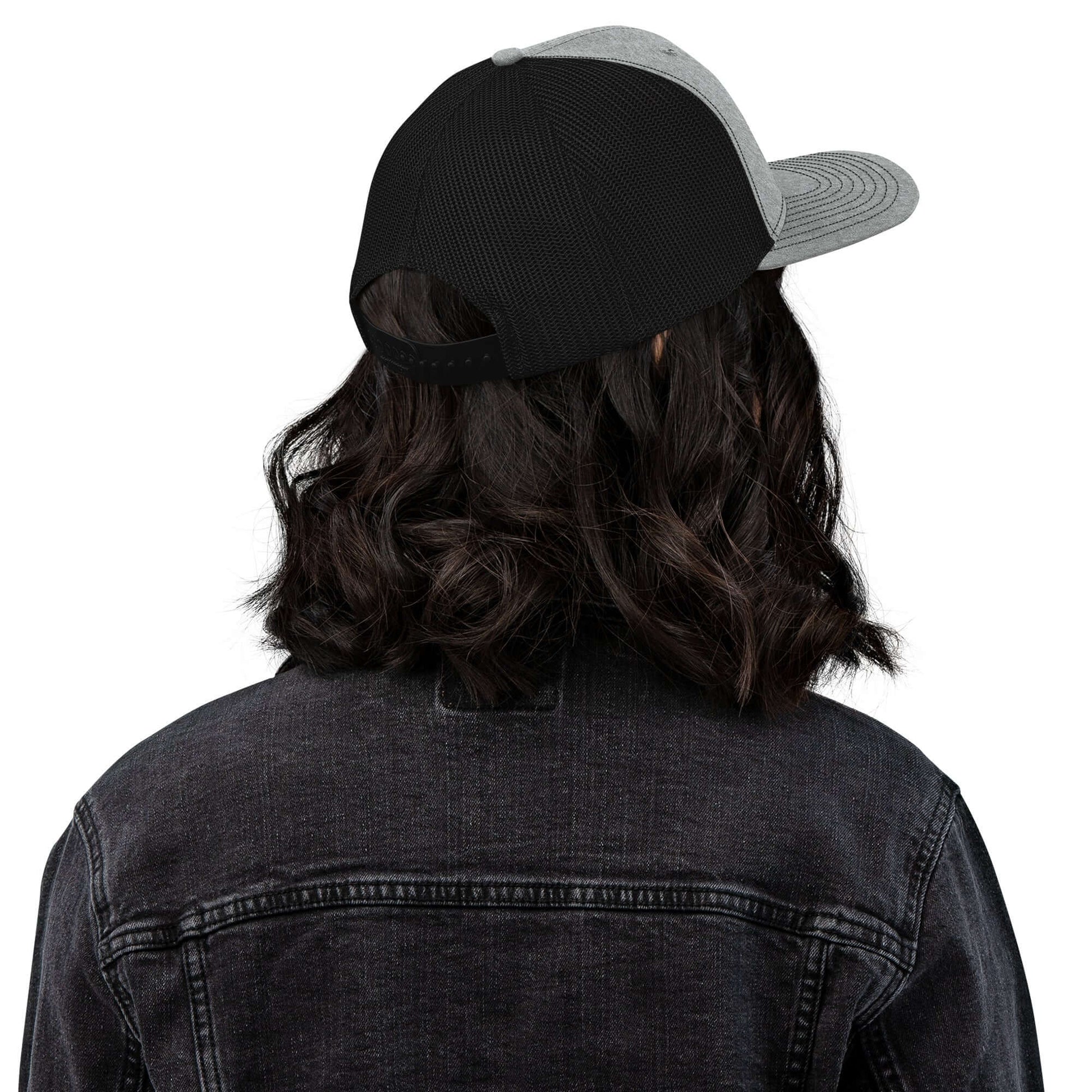 Back view of a person wearing a Trucker Hat By Vellmara with a black and gray design.