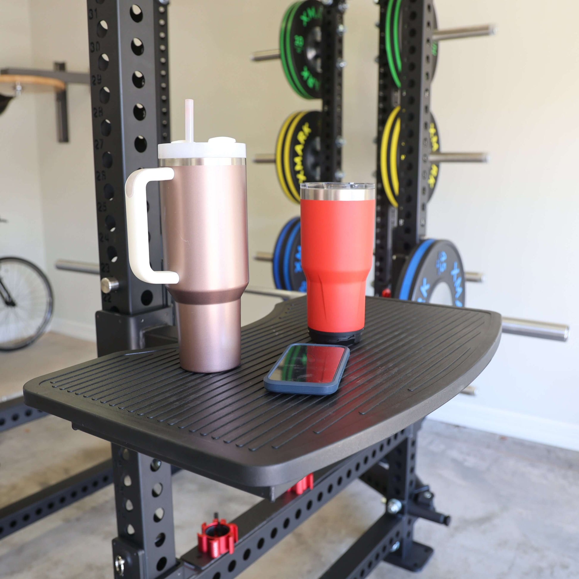 Viper Multi-Purpose Step Attachment shown with two insulated mugs and a smartphone on a power rack.