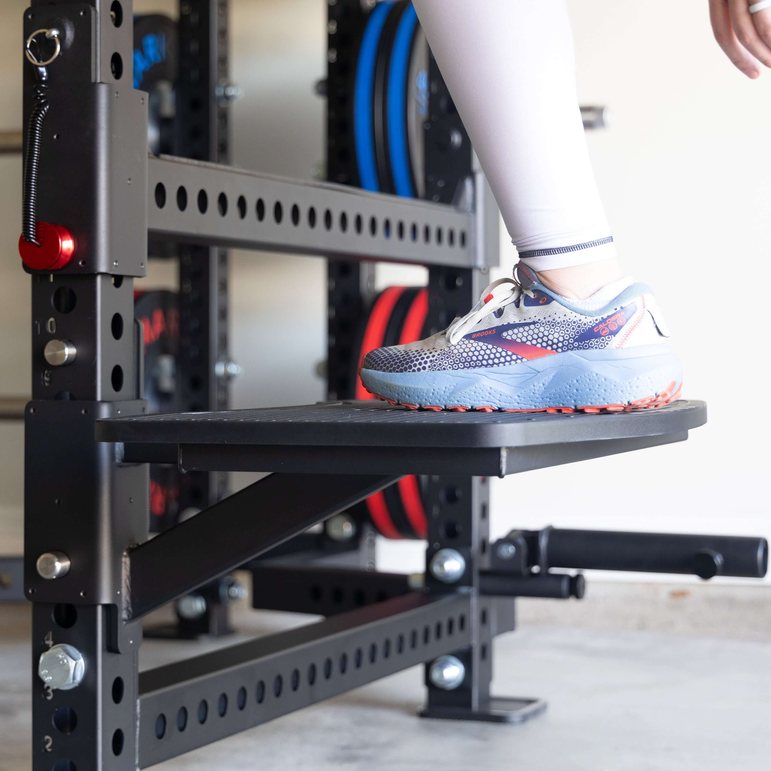 Close-up of a foot on the Viper Multi-Purpose Step Attachment for fitness exercises and workouts.
