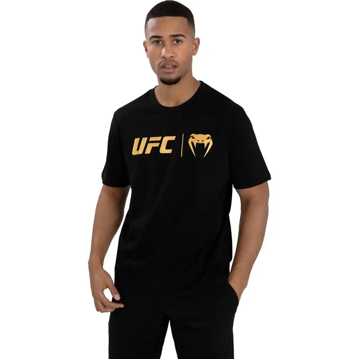 UFC Logo Classic Premium Cotton Tee worn by a man, featuring gold UFC logo on a black T-shirt.
